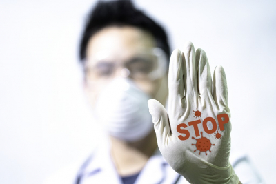 Stop COVID-19 concept. The male doctor is making a stop sign to stop the virus by hand. Doctors holding Coronavirus 2019-nCoV Stop that cause mysterious viral in China Wuhan City