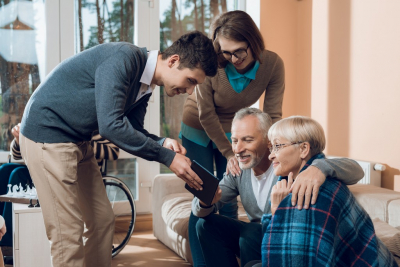 elderly couple with two caregivers